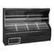 A black Howard McCray horizontal open air refrigerated display with metal shelves.