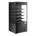 A black vertical air curtain merchandiser with glass shelves.