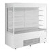 An Avantco white vertical open air refrigerated display case with shelves.