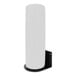 A white cylinder on a black metal surface.