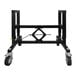 A black metal adjustable support table frame with wheels.