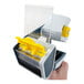 A hand holding a yellow and grey Encore Packaging pistol-grip tape dispenser with clear plastic piece.