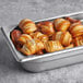 A metal pan filled with Ditsch Authentic German Frozen Soft Pretzel Bites.
