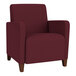 A burgundy Lesro Ravenna guest chair with wooden legs.