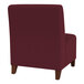 A burgundy Lesro Ravenna guest chair with wooden legs.