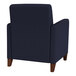 A navy blue Lesro Ravenna guest chair with wooden legs.