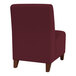 A Lesro Ravenna wine fabric guest chair with wooden legs.