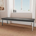 A Lesro Newport Patriot Plus charcoal vinyl bench with silver legs in a lounge area.