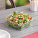 A salad in a clear plastic Sabert bowl.