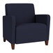 A navy blue Lesro Ravenna oversized guest chair with wooden legs.