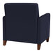 A navy blue Lesro Ravenna guest arm chair with wooden legs.