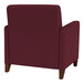 A burgundy Lesro Ravenna arm chair with wooden legs.