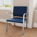 A Lesro Newport Patriot oversized guest chair with blue vinyl upholstery and silver metal arms.