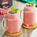 Two glasses of DaVinci Gourmet Wildberry Blast smoothie with berries on top.