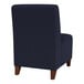 A close up of a Lesro Ravenna navy blue guest chair with wooden legs.