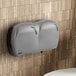 A Lavex Pro titanium double-roll jumbo toilet tissue dispenser on a wall.