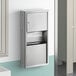 A stainless steel Lavex surface-mounted paper towel dispenser and waste receptacle on a wall.
