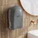 A Lavex Pro automatic foam soap dispenser on a wall next to a tile wall.