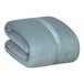 A folded Berkshire Hospitality Serasoft+ blanket in mineral blue.