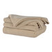 A stack of beige Berkshire Hospitality Polartec Softec king size blankets.