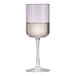 A Libbey wine glass with a pink rim filled with a drink.