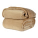 A stack of beige Berkshire Hospitality velvetloft blankets.