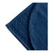 A white polyester quilted bedspread with a blue botanical leaf pattern.