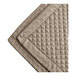 A close up of a truffle colored diamond quilt with a diamond pattern.
