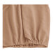 A close up of a beige and brown knit fabric box spring cover.