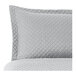 A close up of a grey diamond quilted pillow sham.