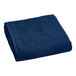 A navy blue Berkshire Hospitality quilt with botanical leaf designs on a white background.