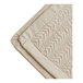 A beige Berkshire Hospitality quilt with a botanical leaf pattern.