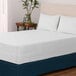 A white Berkshire Hospitality Protextile mattress encasement on a bed.