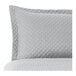 A close up of a grey diamond quilted pillow sham.