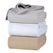 A stack of Berkshire Hospitality white cotton blankets.