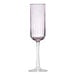 A close up of a Libbey pink flute wine glass with a purple rim.