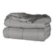 A stack of grey Berkshire Hospitality twin size blankets.