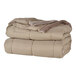 A stack of mocha Berkshire Hospitality blankets.