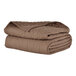 A stack of brown Berkshire Hospitality CozyCare Designs twin size fitted coverlets.