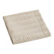 A folded sand colored Berkshire Hospitality quilted pillow sham with a botanical leaf pattern.