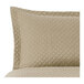 A close up of a Berkshire Hospitality truffle diamond quilted pillow sham.