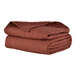 A stack of three nutmeg Berkshire Hospitality CozyCare Designs twin size fitted coverlets.