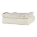 A stack of cream Berkshire Hospitality twin size blankets.
