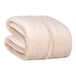 A folded beige Berkshire Hospitality Serasoft+ king size blanket.
