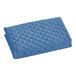 A blue quilted pillow sham with a diamond pattern.