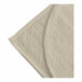 A sand-colored quilted bedspread with a botanical leaf pattern.