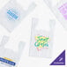 A group of white plastic t-shirt bags with logos.