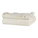 A stack of cream Berkshire Hospitality Microfleece blankets.
