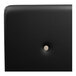 A black leather surface with a beige button on it.