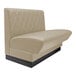 A beige leather booth with a black base.
